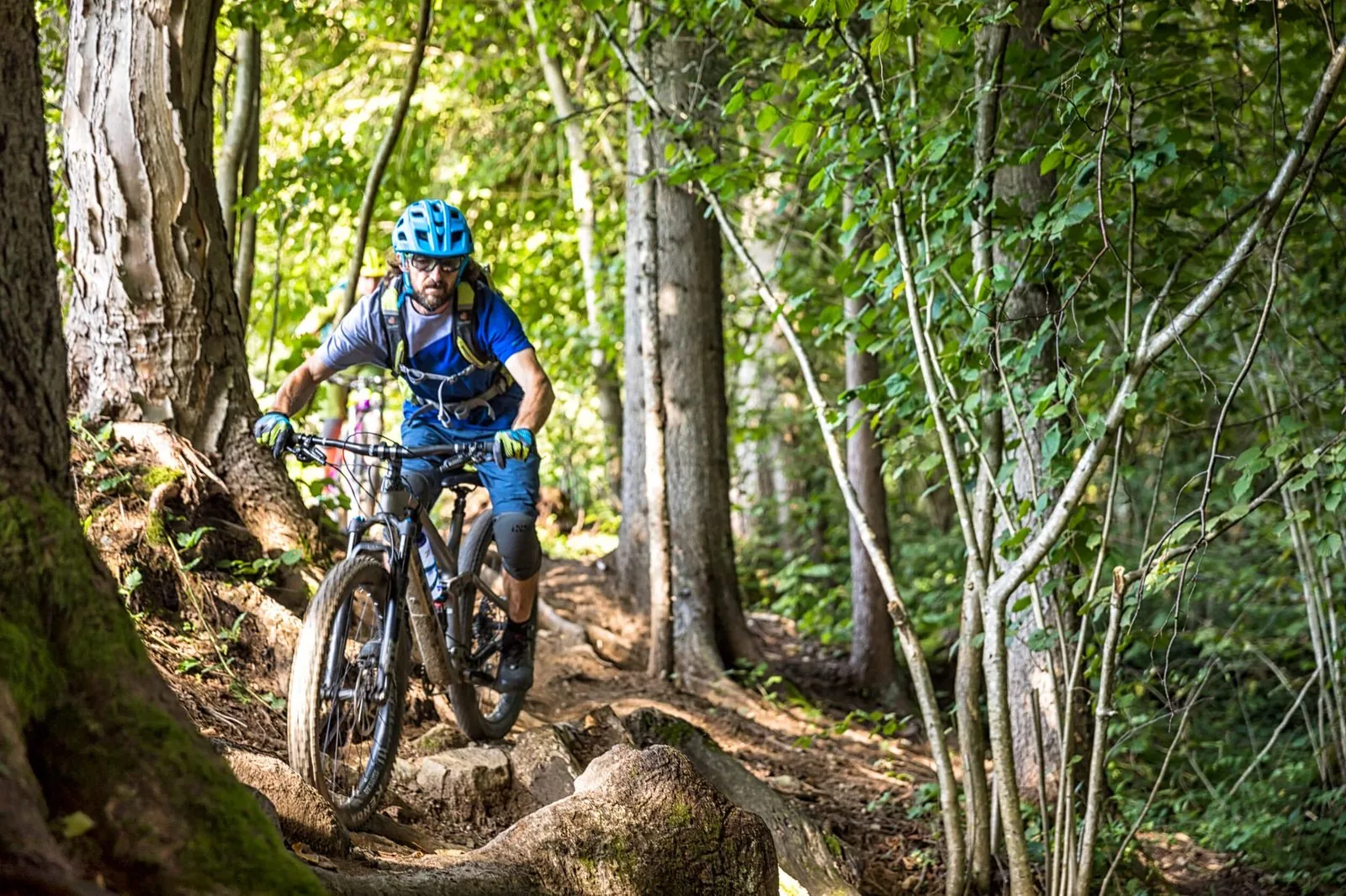 Mountain biker riding a rocky forest singletrack trail in Slovenia