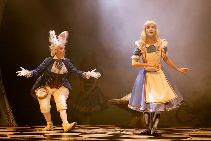 Alice encounters the White Rabbit on stage — a magical moment from the Alice in Wonderland theatrical production