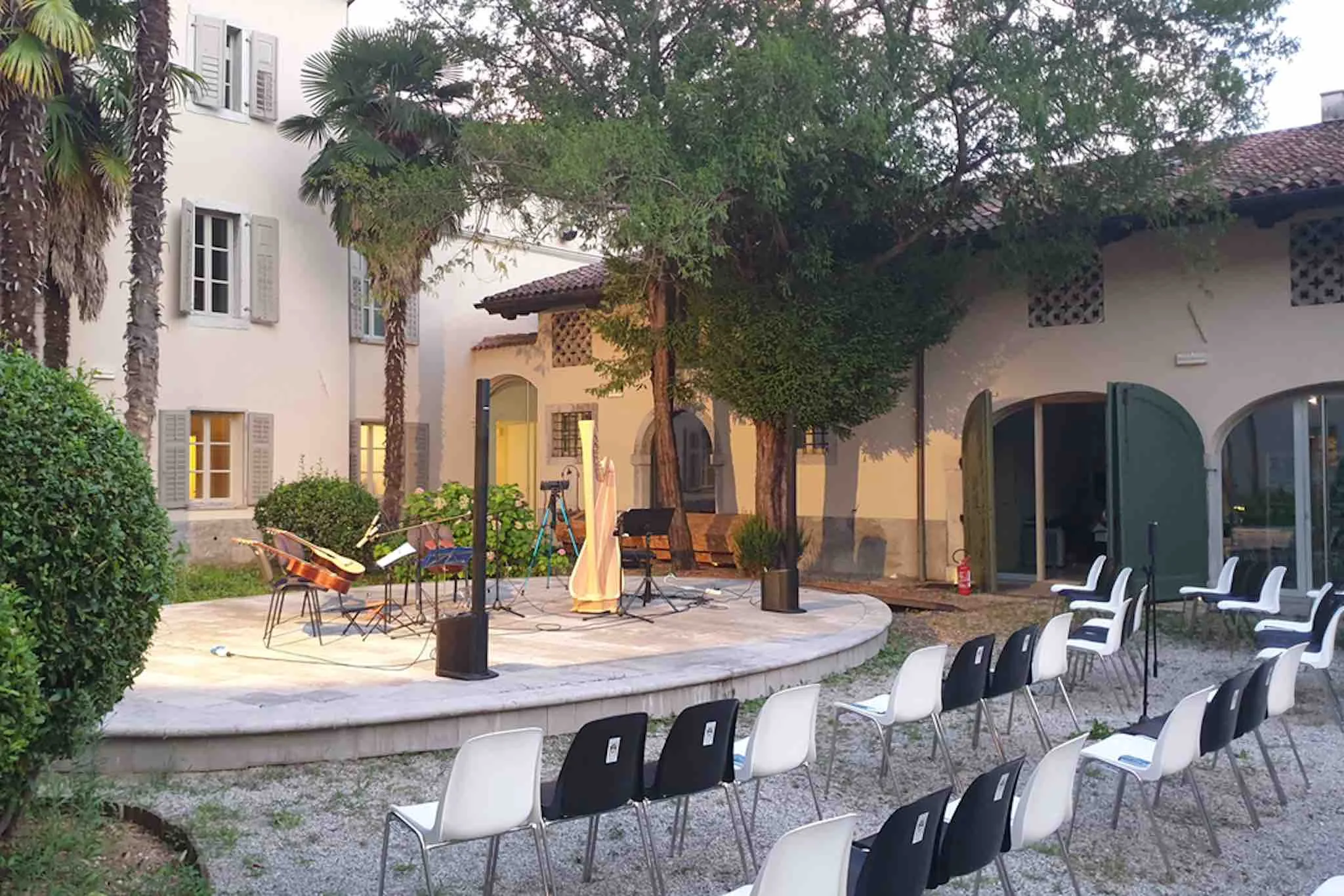 The beautiful courtyard of Palazzo de Grazia in Gorizia, set up for an outdoor cultural event with musical instruments on stage