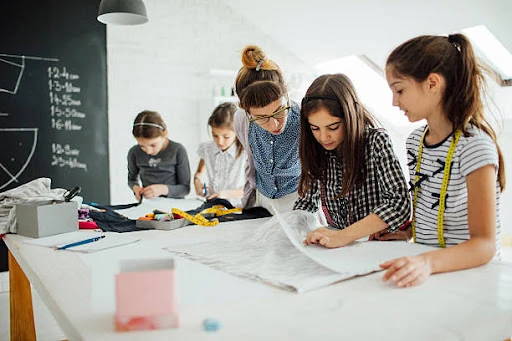 Young participants learning sewing and creative techniques in a workshop