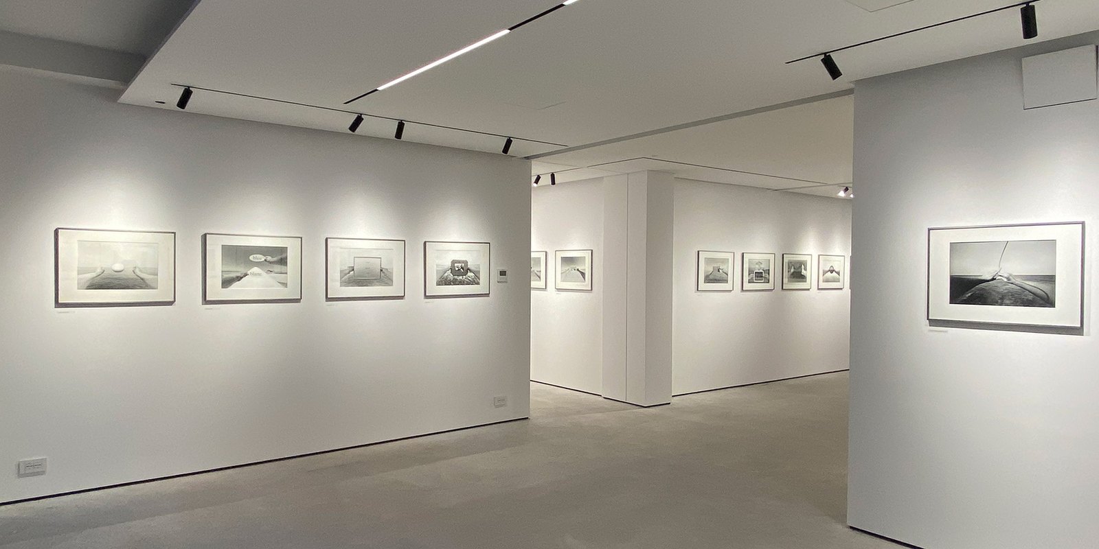 The white interior of Gallery GONG in Nova Gorica with framed black-and-white photographs on the walls