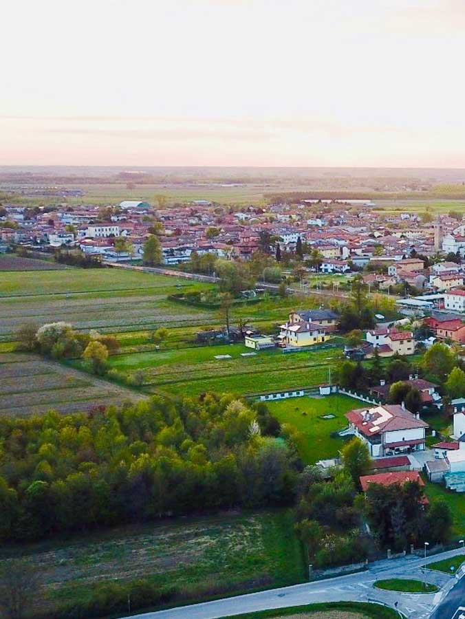 Aerial view of Muzzana del Turgnano village surrounded by green countryside