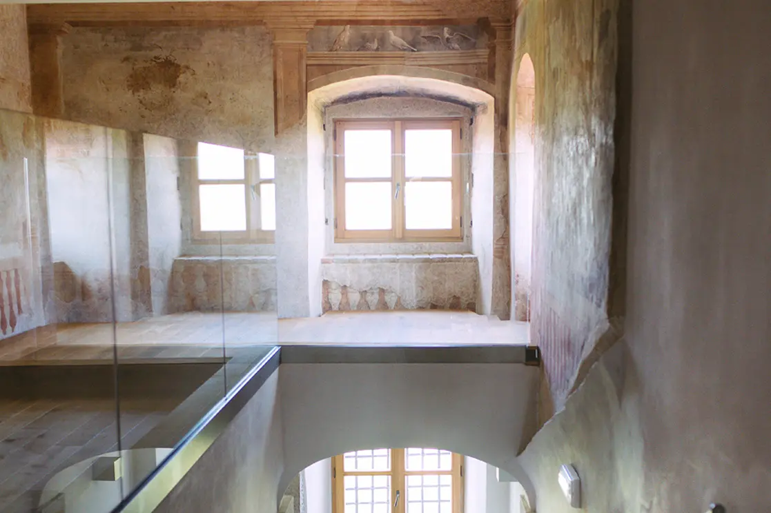 The restored interior of Vila Vipolže, where centuries-old frescoes meet contemporary architecture on the Piano Nobile.